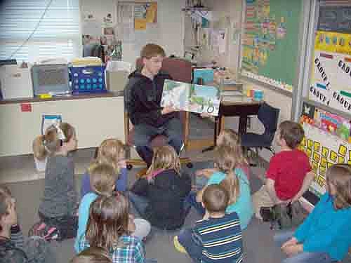 The Stewartville varsity boys basketball team made its annual visit to Bonner Elementary School K-3 grade classes on Feb. 15 to read to students as part of "I Love to Read Month." Here, Jacob Narveson reads to a group of students.