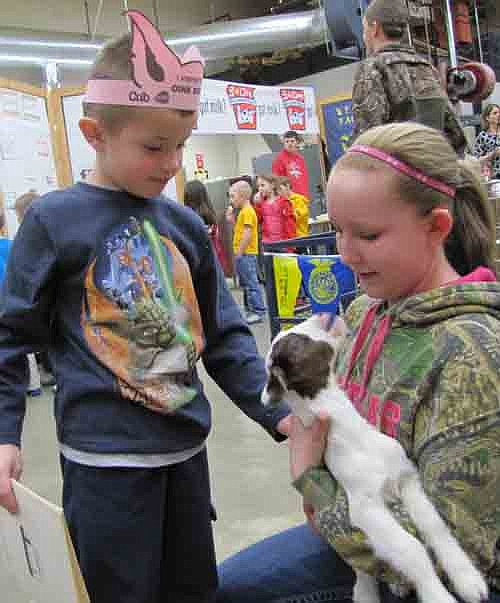 Eli Riggin, a student in Emily Johnson's kindergarten class at Bonner Elementary School, meets a young goat held by Brenna Harvey.