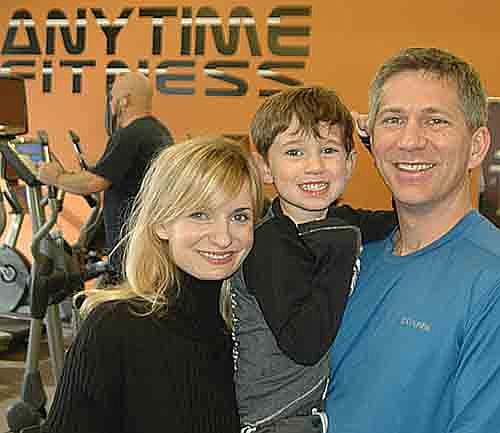 Dan and Lisa Kueker, the new owners of Stewartville's Anytime Fitness, are pictured with their son, Remington. Todd Looney, general manager, said that Anytime Fitness is much more than just a workout center. "We want to have empathy for people, anticipate their needs and encourage them," he said. "We greet people with a smile." 