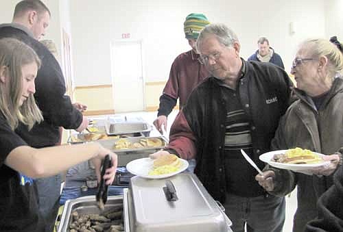 Makayla Morgan, a freshman FFA member at Stewartville High School, left, serves guests at the Stewartville FFA Farmer's Share Breakfast at the Stewartville Civic Center on Saturday, Feb. 23.
