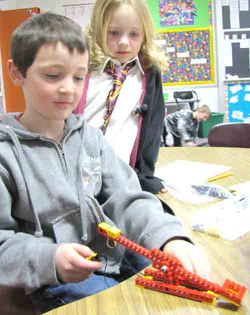 Bonner Elementary School students are using LEGOS to make levers in special classes after school on Thursdays. Here, Jake Schimek focuses on his LEGO device as Isabelle Lukes looks on in the background.
