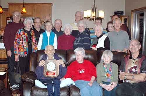 Roger Knutson, seated at far left next to his wife, Peggy, accepts the Outstanding Achievement Award from the Stewartville Wrestling Booster Club. Over the years, Knutson played a key role in starting Stewartville's youth wrestling program, the Wrestling Booster Club, a Freestyle Wrestling Club and the end-of-the-season wrestling banquet. Wrestling requires a special kind of dedication, he said. "There is a lot of self-sacrifice," he said.