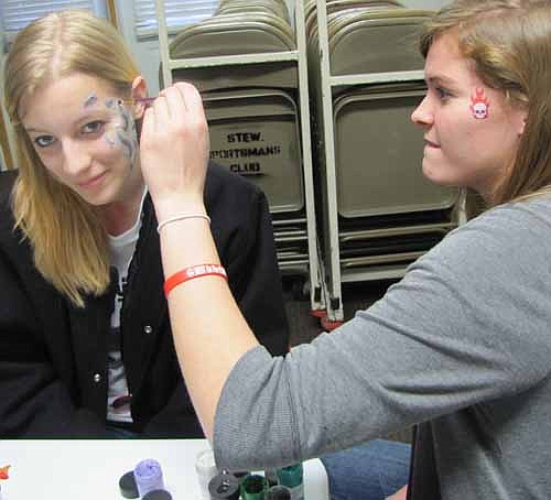 Nikki Skifton, a member of the Stewartville High School National Honor Society, right, paints Hope Deetz's face at the NHS benefit to fight cancer at the Stewartville Sportsman's Club on Saturday, March 16.
