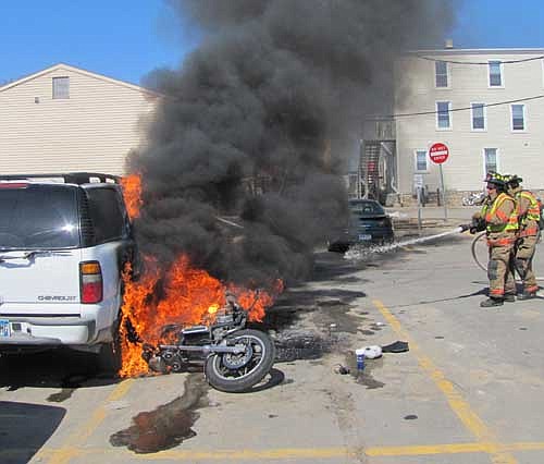 Nine Stewartville firefighters responded to a fire at the parking lot west of Sammy's Family Restaurant on Wednesday, April 3 at about 1:50 p.m.  A 1984 Honda motorcycle caught fire, tipped over and fell toward a 2004 Chevrolet Tahoe, which was soon swallowed up in flames.
