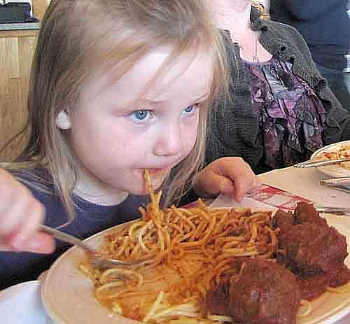 Lily Lukes, 4 1/2, of Stewartville, enjoys her spaghetti and meatballs at the Mama Tranchita Dinner at the Riverview Greens Country Club on Tuesday, April 2. "It's yummy," she said.