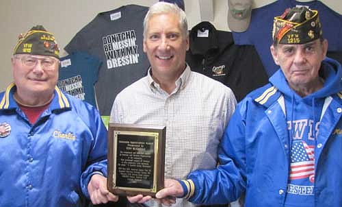 Charlie Baker, left, and Mike Dexter, right, members of the Whitlock-Sonnenberg VFW Post 1215 of Rochester, present Tom Slightam, owner of Jimmy's Salad Dressings & Dips of Stewartville, a plaque thanking Slightam and Jimmy's for its "exceptional and dedicated support to veterans and veterans organizations in the community."  The plaque also states, "Your prolonged support of veterans in this community truly epitomizes the adage, 'A Grateful Nation Remembers.' " Slightam was touched by the honor. "I humbly thank you," he told Baker and Dexter.