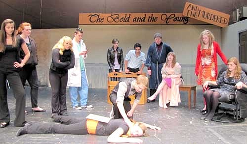 Micah Ostergard (Morris Nyborg)&#8200;finds Calli McCartan (Lena), the director, dead as the other cast members look on during a dress rehearsal for the Stewartville High School production of The Bold, the Young and the Murdered. Other cast members include, from left, Adriana Nelsen-Gross, Monika Anderson, Madelyn Miller, William Miller, Kaitlyn Claeys, Vosco Diogo, Nathan Lange, Cassidy McCartan, Kaylyn Hildebrandt and Nikki Skifton.