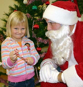 Sarah Oeltjenbruns visits with Santa. 