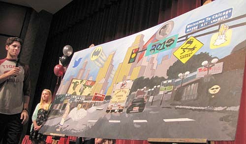 Zach Schwalbach presents the Stewartville High School class of 2013's senior mural at the annual Academic Awards Assembly at the Performing Arts Center last week.