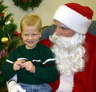 A CHRISTMAS SMILE -- Levi Patterson, 5, a kindergartner at Bonner Elementary Schools, smiles as he thinks about his Christmas wish list while visiting with Santa at the Stewartville Civic Center on Saturday, Dec. 1. 