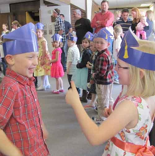 Ava May, right, gives classmate Ethan McMurdo a thumb's up at the annual Wee Care graduation at St. John's Lutheran Church on Sunday, May 5. Ava and Ethan are two of the 68 Wee Care graduates who celebrated their graduation that day.