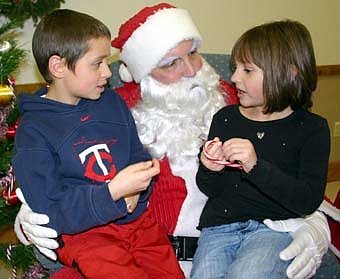 Adam (left) and Samantha Koenigs visit with Santa. 