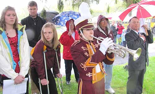  Laura Louks, front and center, plays taps as, from left, eighth-grade essayists Libby Christenson and Christina Anderson and Mayor Jimmie-John King, far right, listen on Memorial Day morning May 27. 