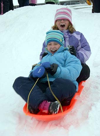 Central Intermediate School's fourth-graders had plenty of fun sledding down the steep hill near the school last Thursday, Dec. 6. Brenna Harvey, in front, closes her eyes and hangs on as Kari Johnson, in back, shouts for joy. A number of recent storms have provided ample snow. 