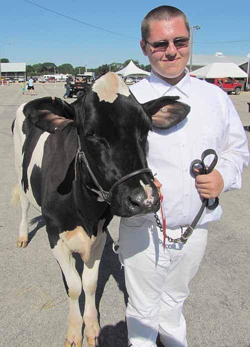 George Skare, 15, a member of the High Forest Chippewa Champions 4-H Club, showed "Meg," a summer junior yearling Holstein.