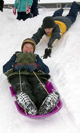 Central Intermediate School's fourth-graders had plenty of fun sledding down the steep hill near the school last Thursday, Dec. 6. Tyler Reed smiles broadly as he heads down the hill thanks to a strong push from Dalton Miller. 