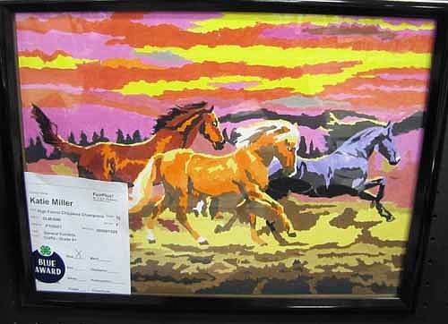 Katie Miller of Stewartville earned a blue ribbon for her painting of three running horses.