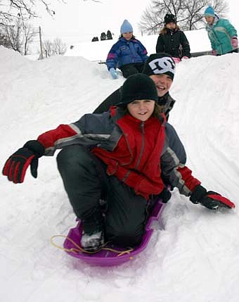Central Intermediate School's fourth-graders had plenty of fun sledding down the steep hill near the school last Thursday, Dec. 6. Derek Krenke, in front, and Dylan Stofferahn, in back, strive to remain upright as they make their way down the hill. 