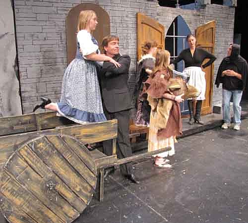 Inga (Kallie Quinn), left, is lifted from the cart by Fred (Randy Peterson) to meet a skeptical Frau Blucher (Laurie Helmers, in the doorway) during a dress rehearsal for Stewartville Community Theatre's Young Frankenstein.