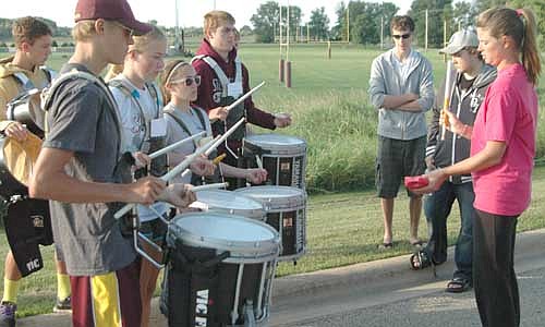 Jessica Honsey, the director of the Stewartville High School Band, above right, works with the band's drummers at SHS&#8200;Band Camp last week. Band Camp is always a challenge, Honsey said. "Band Camp is a great way to start learning about the correctedness we need to have as a performing ensemble," she said.