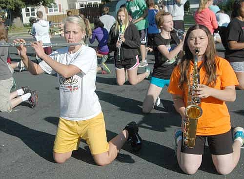 Jessica Rosenblad, left, plays the flute and Christine Deetz plays saxophone as the SHS&#8200;Marching Band hit the streets of Stewartville last week.