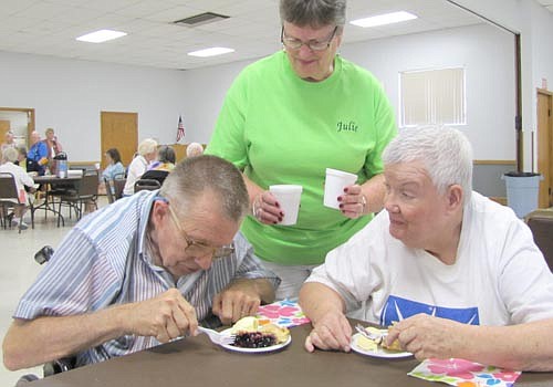 Julie Jaeger serves water to John and Bertha Maloney at the pie and ice cream social at the Stewartville Center for Active Adults last Thursday, Aug. 15. Local and area residents over 50 years old received free pie and ice cream. Casey & the Good Timers Band played a number of classic favorites.