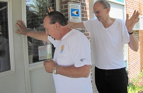 Rick Scott, pastor of Stewartville Assembly of God Church, left, pauses to pray for the students who will learn and the teachers, staff members and administrators who will work at Central Intermediate School during the 2013-14 school year.