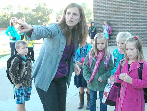 Kristina Ramaker, a paraprofessional at Bonner Elementary School, points a group of students in the right direction on the first day of school last week. Students include, from left, Mason Holtan, Grace Nelson, Holly Sexton and Calista Younge.