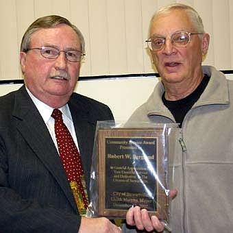 Bob Bergland, right, was honored at the city of Stewartville's annual appreciation open house last Wednesday, Dec. 12. Mayor Chuck Murphy presented Bergland with the Mayor's Award for Community Service. 