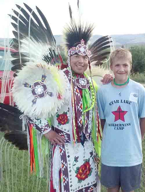 Students from Stewartville United Methodist Church who traveled to the Wind River Indian Reservation in Wyoming this past summer. Here, Colton Reed poses with a Native American dancer. Jeremy Krekula, a young adult who took the trip, said that the journey helped the young people live out Jesus's command to love one another.