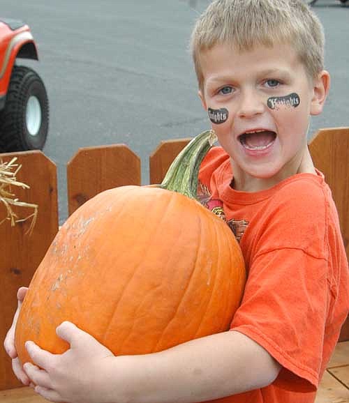 Stephen Gensmer picks out his pumpkin at the Stewartville Fall Festival on Saturday, Sept. 28.