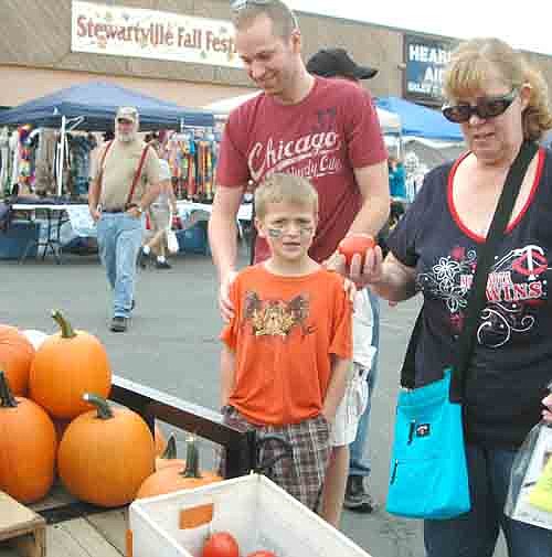 Sue Gensmer of Stewartville, right, accompanied her son Stephen, center, and grandson Lucas to the Stewartville Fall Festival on Saturday, Sept. 28. The Gensmers spent time looking over the pumpkins and tomatoes.