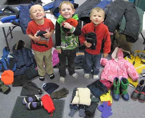 The Stewartville Child Care Center has collected coats, scarves, boots, snow pants, snow suits, mittens, gloves, hats and other winter items for the United Way of Olmsted County's winter clothing drive. Items will be donated to area individuals and families who don't have the financial means to buy winter clothing. Children from the Child Care Center posing with the clothing include, from left, Keegan Fetterly, Dane Cole and Oliver Mai.