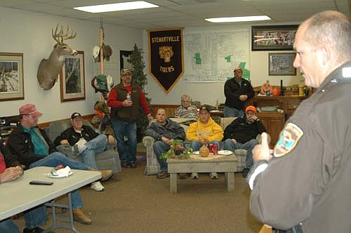 Zak Breitenbach, Stewartville's community oriented policing (COPS) deputy, far right, discussed safety issues with drivers for Grisim School Bus Inc. last week. Breitenbach's presentation focused on what drivers should do if an intruder boards a school bus. Curt Grisim, co-owner of Grisim Bus, said that the company hosts safety sessions for its drivers on early-release days about once a month.