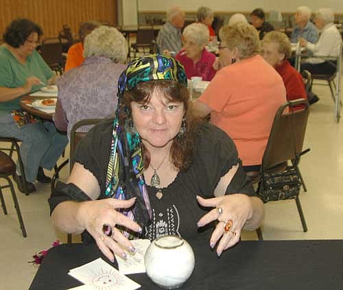 Linda Miller, Site Coordinator for the Center for Active Adults, formerly the Stewartville Senior Center, demonstrates her "powers" as a fortune teller. Linda, a/k/a Madam Zolinda, read fortunes for free and we were told she only used her powers for good!