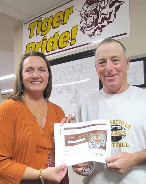 Jimmie-John King, right, was honored as the recipient of the Stewartville School District's first Tiger Token for the 2013-14 school year at last week's School Board meeting. Sheila McNeill, curriculum director for the district, presented the honor.