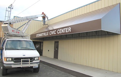 Workers from Abel Signs Inc. of Kasson finished installing a new vinyl awning at the back entrance to the Stewartville Civic Center last Thursday, Nov. 7. Barb Neubauer, city finance director,  said that the city paid $9,400 for the awning and a total of $17,000 for the total spruce-up project, which included design work, new fencing, painting, concrete work, new planters and blacktop work.