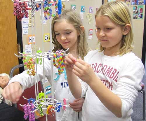 Makena Meyers, 9, of Stewartville, a third grader at Central Intermediate School, right, looks over the bracelets at Cuddly Cow, her mother Jacquie's business, at the annual One-Stop Christmas Shop sponsored by St. John's Wee Care on Saturday, Nov. 23. Caitlin Fenske, 7, of Stewartville, a second grader at Bonner Elementary School and Makena's friend, also browses for a bracelet.