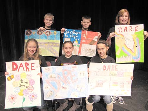 Sixth graders at Stewartville Middle School made posters highlighting a lesson they learned from the D.A.R.E. (Drug Abuse Resistance Education) class they took during the first quarter of the 2013-14 school year. Students who were honored for their posters at last week's D.A.R.E. culmination ceremony include, front row, from left, Gloria Nelson, Lily Welch and Anna Buckmeier. Back row, from left, Benjamin Phelps, Bennett Gross and Domonique Thomley.