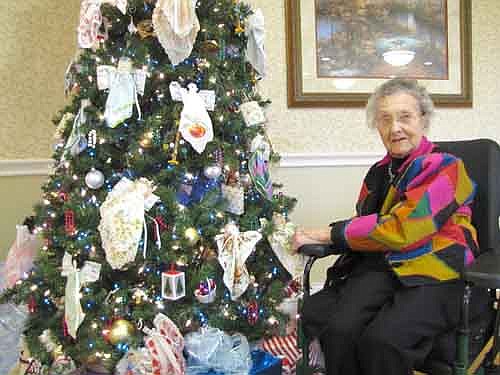 Juliet Seim, 101, a resident of the Stewartville Care Center, sits near the Christmas tree that stands at the Care Center's dining hall. Sunshine Sanitation of Stewartville donated the tree, which was displayed at the Hiawatha Homes Foundation Festival of Trees in Rochester. Linda Klinsporn, Kelly Tollefson and Katha Johnson designed the decorations on the tree.