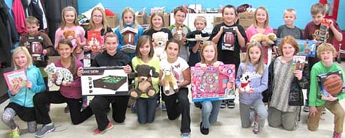 Students at Central Intermediate School brought in more than 500 gifts for the Stewartville Lions Club's 2013 Christmas Anonymous gift and fund drive earlier this month. Lions Club members then distributed the gifts to the Rochester Area Distribution Center. Students displaying some of the many gifts include, front row, from left, Dyllon Lohmann, Mya Wangen, Khloee Zelinske, Hannah Swisher, Maddy Urban, Madigan Lawrence, Sarah Engel, Alashia McMurdo and Miles Hettinger. Back row, from left, Dylan Smith, Ella Waltman, Alexis Goetsch, Chloe Biever, Miah Mikel, Ben Hagen, Xavier Kassel, Elijah Wyant, Abbi Parry, Conner Lohmann and Isaac DeYoung.