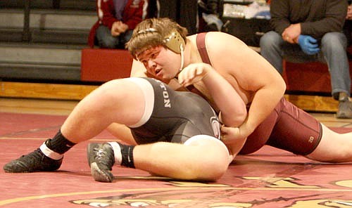 Kyle Lipke drives the shoulders of his 285-pound Triton opponent to the mat before recording the pin.