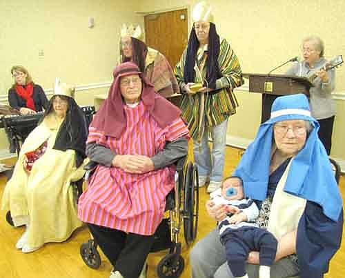 Martha Vogen (Mary) holds Brekken Kiefer (the Baby Jesus) as LeVerne Meyerhofer (Joseph)&#8200;looks on during the Living Nativity at the Stewartville Care Center on Christmas Eve morning, Tuesday, Dec. 24. Wise men in  back include, not necessarily in order, Verna Berge, Don Kolbert and Lyle Hall. Suz Eberle, far left, was the pianist for the event. Jeanette Fortier, at right in back, was the guitarist and narrator.