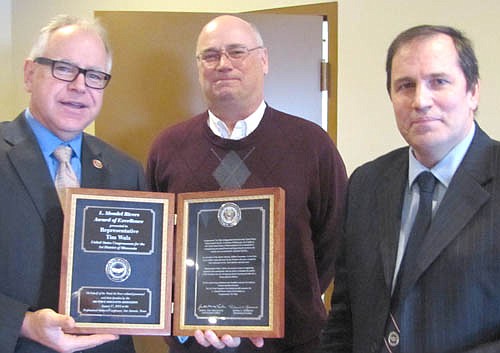 U.S. Rep. Tim Walz, left, accepts the L. Mendel Rivers Award from Jeff Gustafson, retired chief master sergeant, U.S Air Force, center; and Don Roden, master sergeant retired and a member of the Air Force Sergeants Association Chapter 858, right.