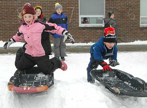 Addison Emmons, left, and Jaxson Evjen, first graders at Bonner Elementary School, raced to be the first to reach their sleds and then headed down the hill during afternoon recess on Friday, Jan. 10. Stewartville's students missed school on Monday, Jan. 6 and Tuesday, Jan. 7 after temperatures plunged to 23 below zero and wind chills reached about 50 below.