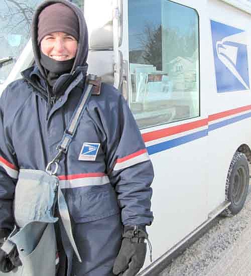 Jill Guy, mail carrier for the U.S. Postal Service, bundled up against the cold on a blustery day last Thursday, Jan. 16. Strong winds led Stewartville school officials to cancel classes before noon that day. Guy and other carriers who worked that day lived up to the words chiseled in gray granite over the entrance to the New York City Post Office on Eighth Avenue: "Neither snow, nor rain, nor heat, nor gloom of night stays these couriers from the swift completion of their appointed rounds."