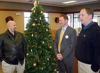 HAPPY HOLIDAYS -- Mark Rusciano, president of First Farmers&Merchants State Bank, second from right, hosted a "celebrate the holidays" open house at the bank on Wednesday, Dec. 19. Guests enjoyed breakfast pizza, hot cider and more. Glenn Belen, far left, and Greg Schimek, right, enjoyed convesation with Rusciano.  