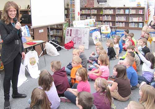 Mary Evanson Bleckwehl, an award-winning children's author, speaks to kindergartners at Bonner Elementary School on Monday, Feb. 3. She read from her book, Henry! You're Hungry Again? about a boy who eats too much junk food and doesn't feel big and strong afterward.