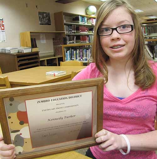 Kennedy Parker, a sixth grader at Stewartville Middle School, displays her award for her exemplary prose in the Zumbro Education District (ZED) Creative Writing Contest.
