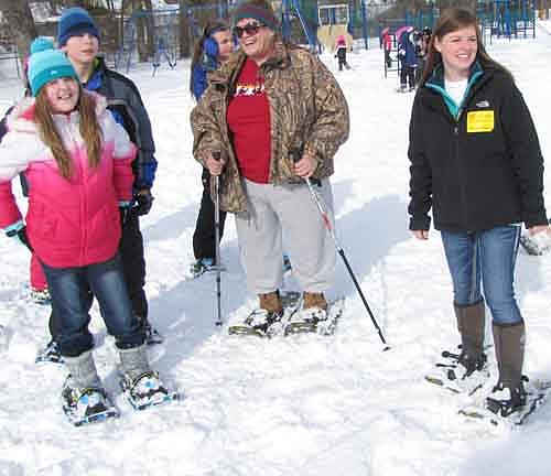 Students at Central Intermediate School tried out their new snowshoes from Cabela's of Owatonna last week. Here, Barb Hill, physical education teacher at Central, center, and Beckie Moreau of Cabela's, right, take a break with students Baylee Edwards, far left, and Nick Otto.